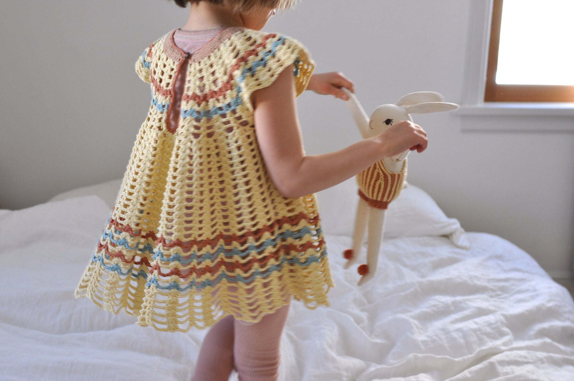Polka Dot Club rabbit toy in Misha and Puff hand knit romper. Bunny dolly
